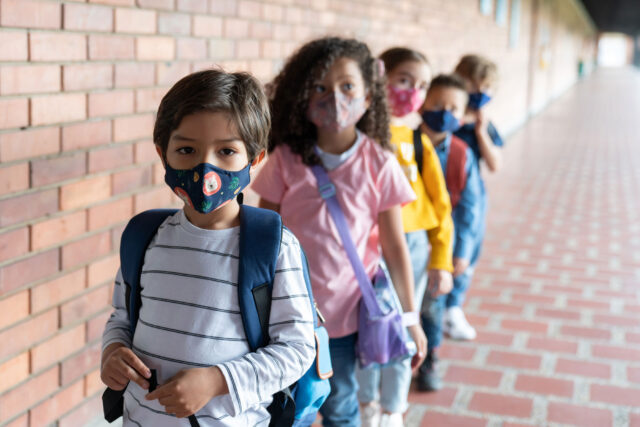 photo - Students Lined Up Outside Classroom and Wearing Masks
