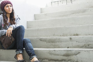 photo - Young Woman Sitting on Stairs